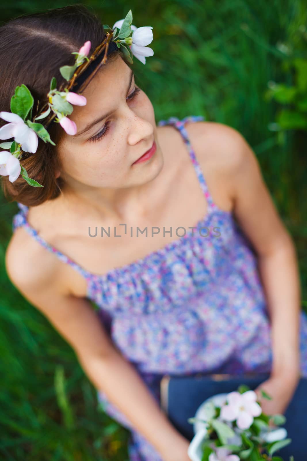 Adorable girl in blooming apple tree garden on spring day