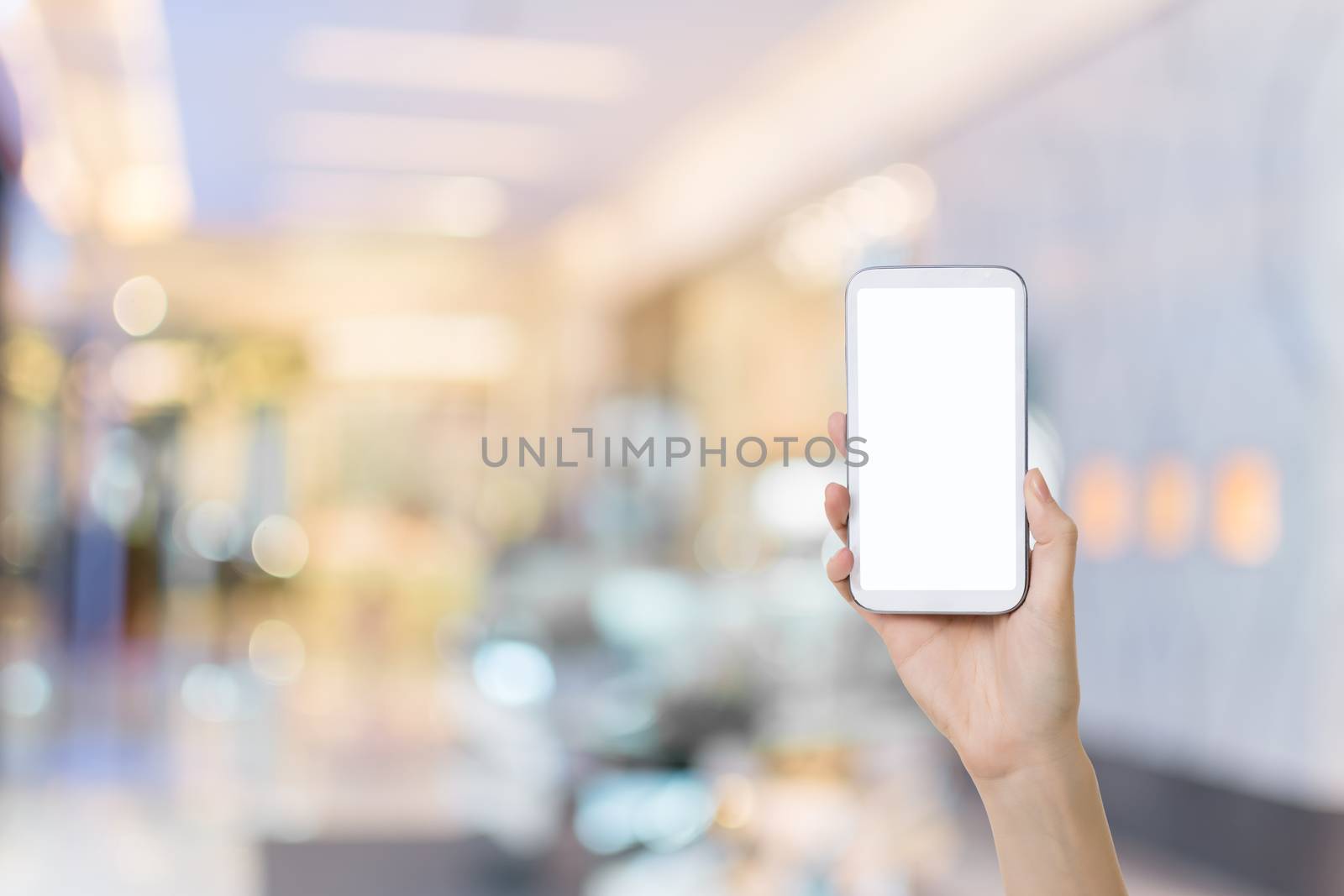 Using smartphone in a market or department store, closeup image.