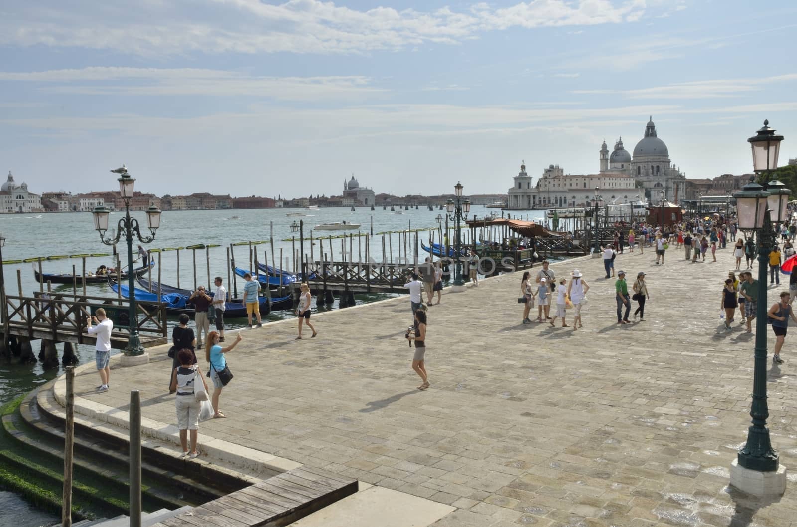 A group of tourists along the Grand Canal in Venice, Italy.