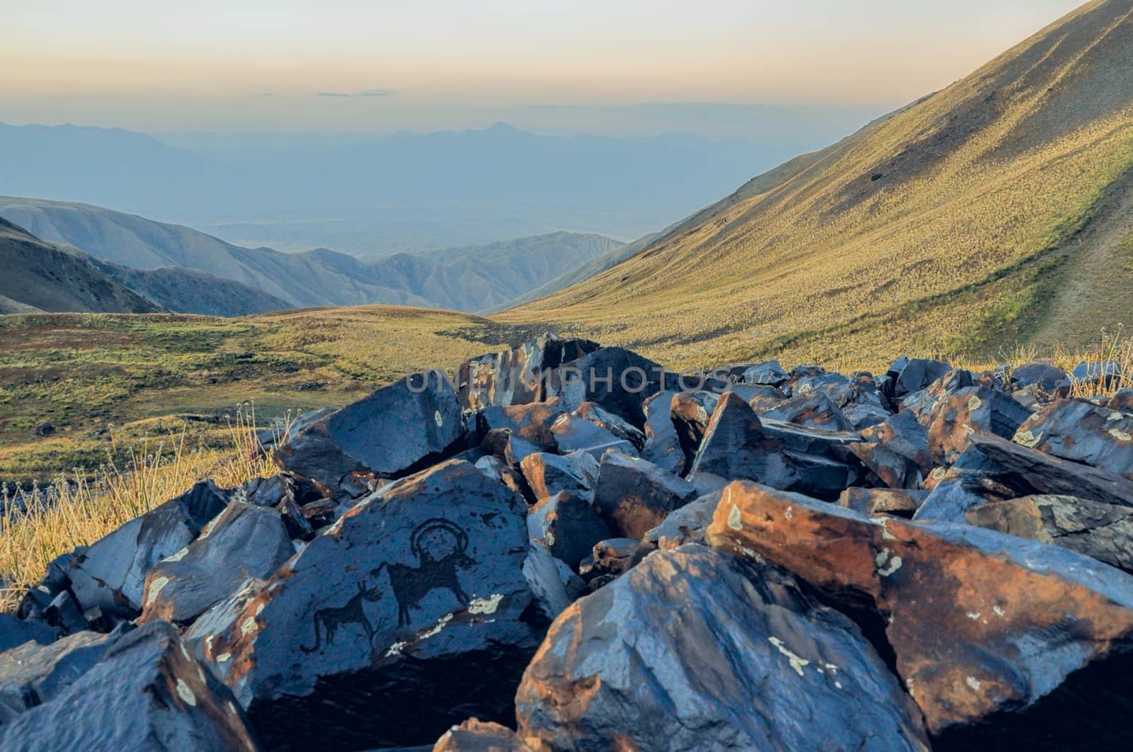 Ancient rocks with pictograms on Saimaluu Tash site in Kyrgyzstan