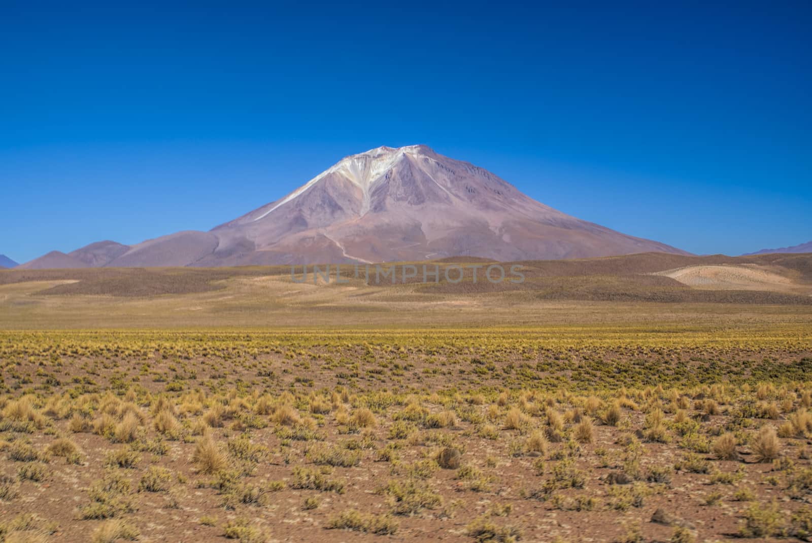 Scenic volcano near salt planes Salar de Uyuni in bolivian desert