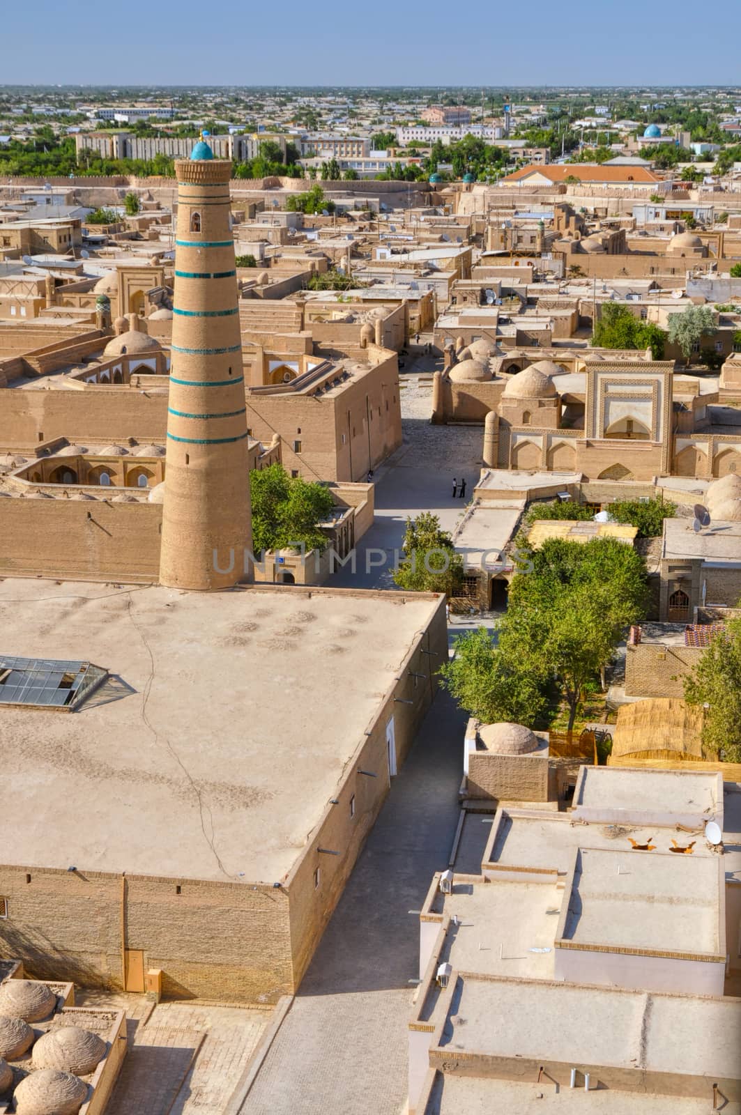 Scenic aerial view of streets in old town in Khiva, Uzbekistan with large mosque
