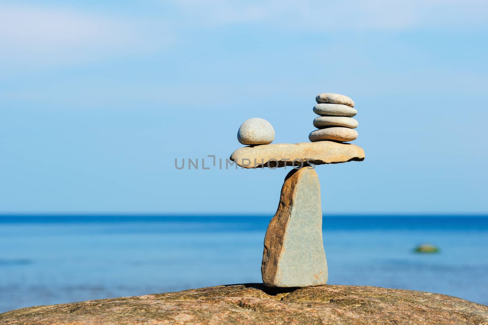 Balancing of pebbles on the top of triangle stone