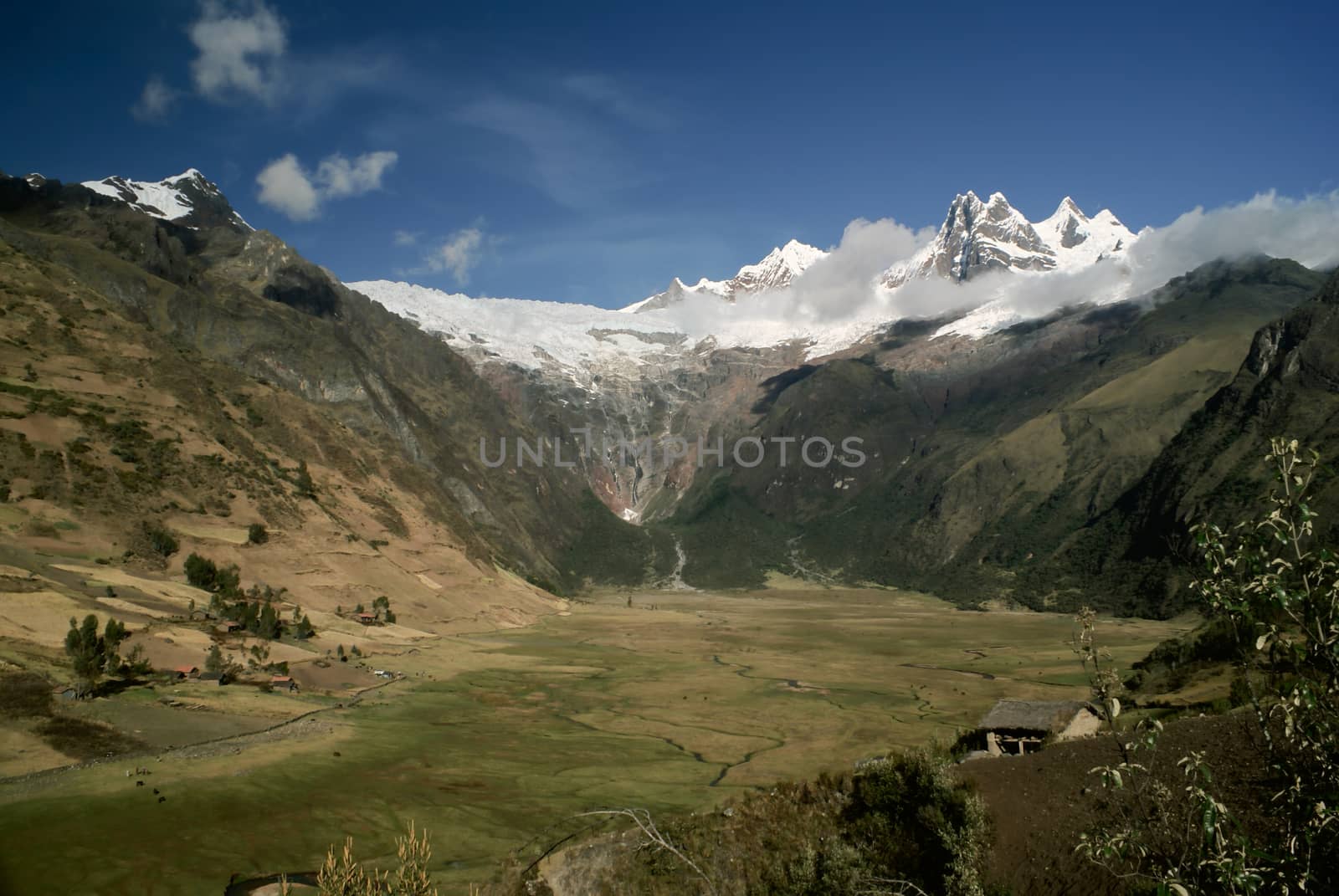 Scenic green valley in between high peaks of mountains in Peruvian Andes