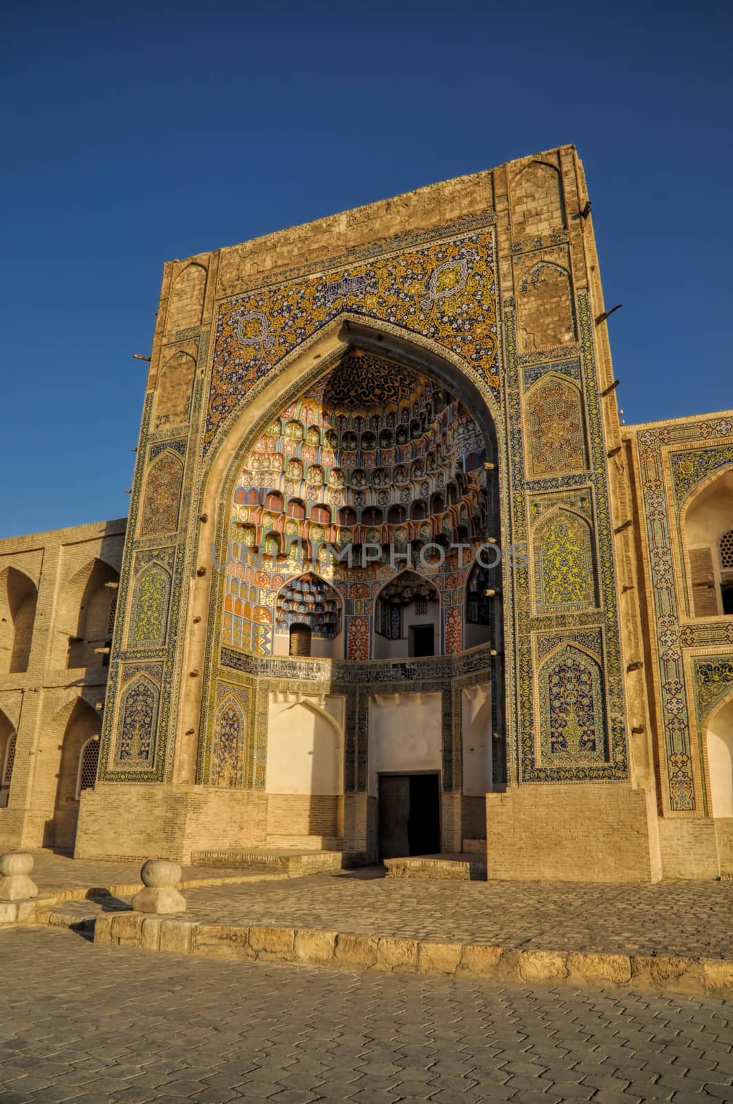 Picturesque view of the Abdulaziz Khan Madrassah (Museum of Wood Carving Art) in the setting sun 