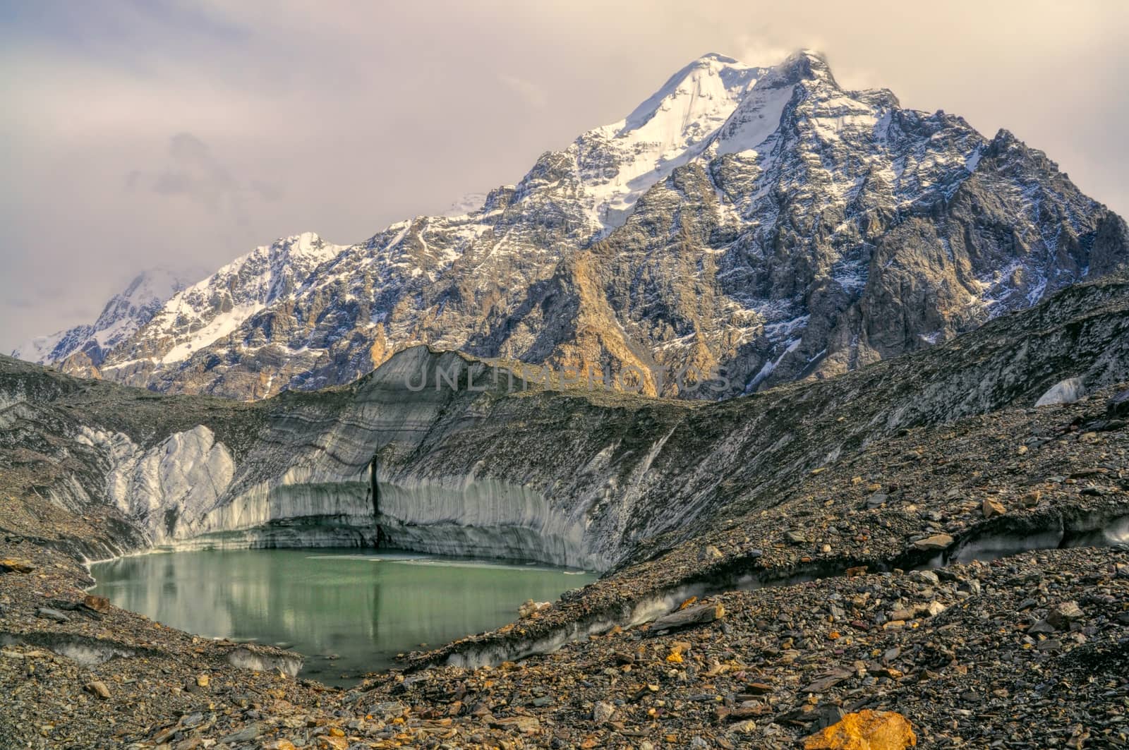 Lake on Engilchek glacier under peaks of scenic Tian Shan mountain range in Kyrgyzstan