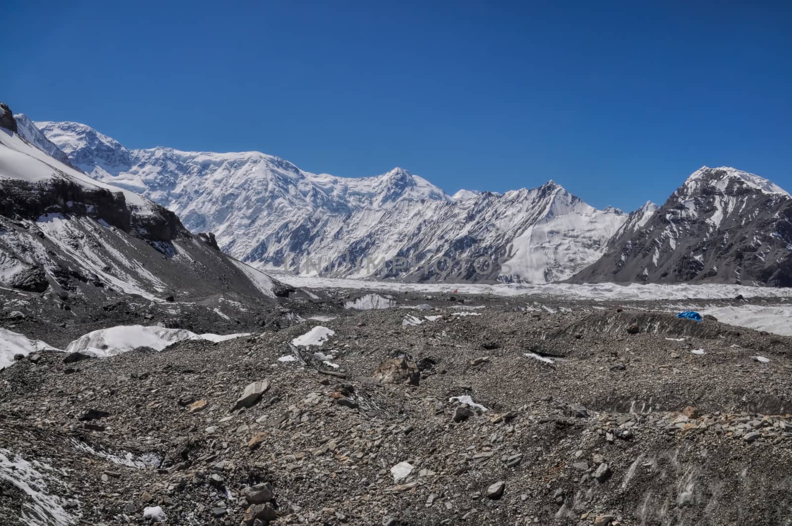 Scenic snow-covered mountain peaks around Engilchek glacier in Tian Shan mountain range in Kyrgyzstan