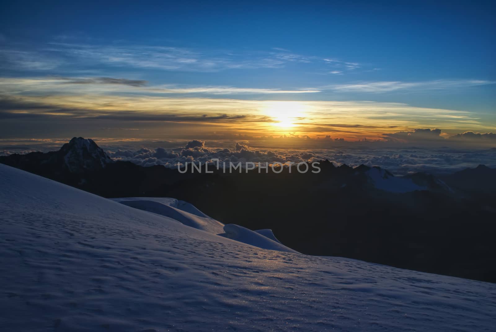Scenic sunrise from mountain peak above clouds in Bolivian Andes