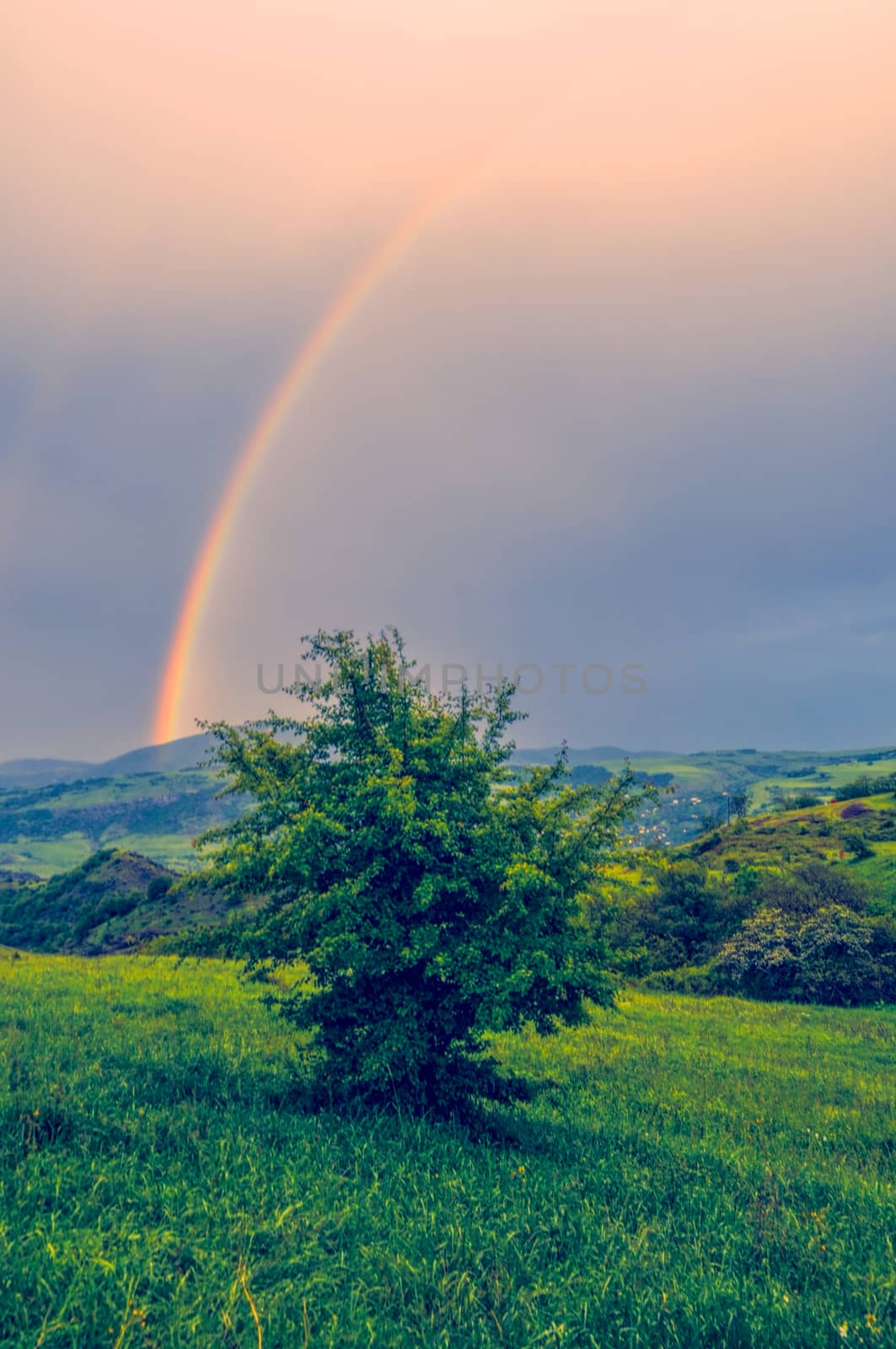 Rainbow over green landscape of mountainous Karabakh