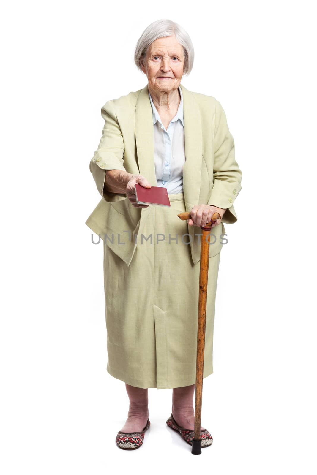 Senior woman giving passport over white by photobac