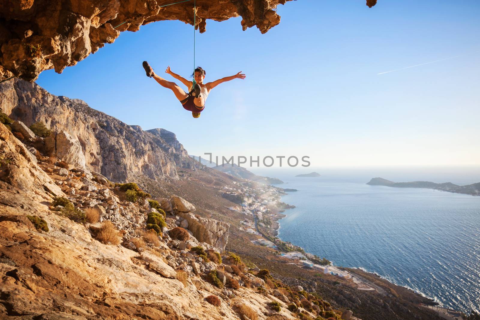 Female rock climber falling of a cliff by photobac
