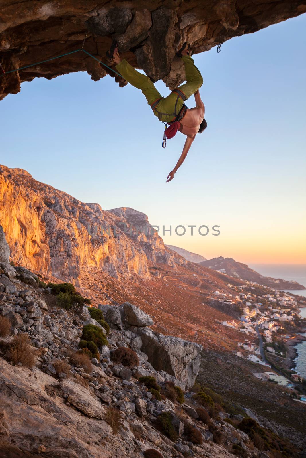 Male climber on overhanging rock by photobac