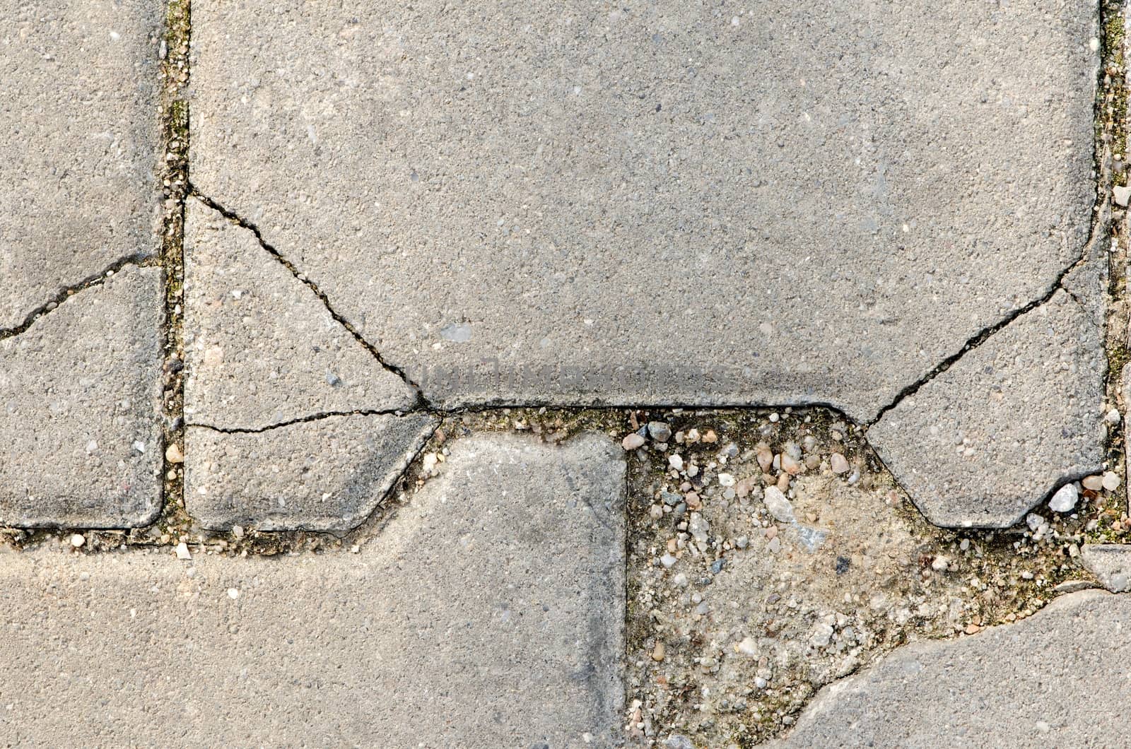 Crackled stone pave with dirt, concrete path texture.