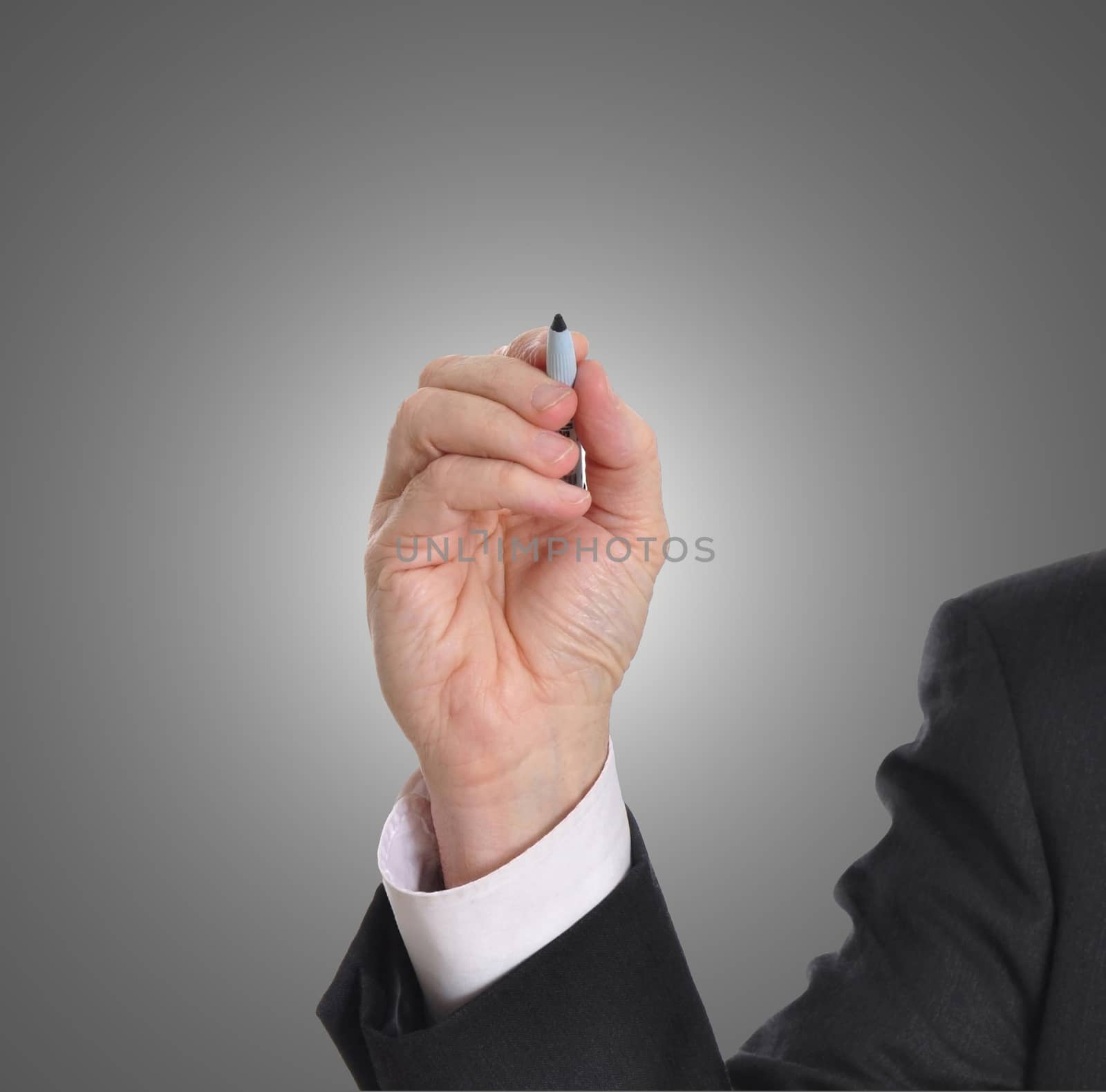 Businessman writing with marker isolated on gray background. Plenty of room for a message.