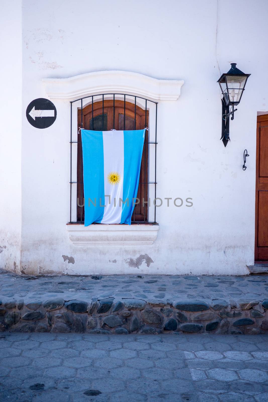 Argentinian Flag Hanging On Patriotic House in Small South Ameri by CDuncombeStock