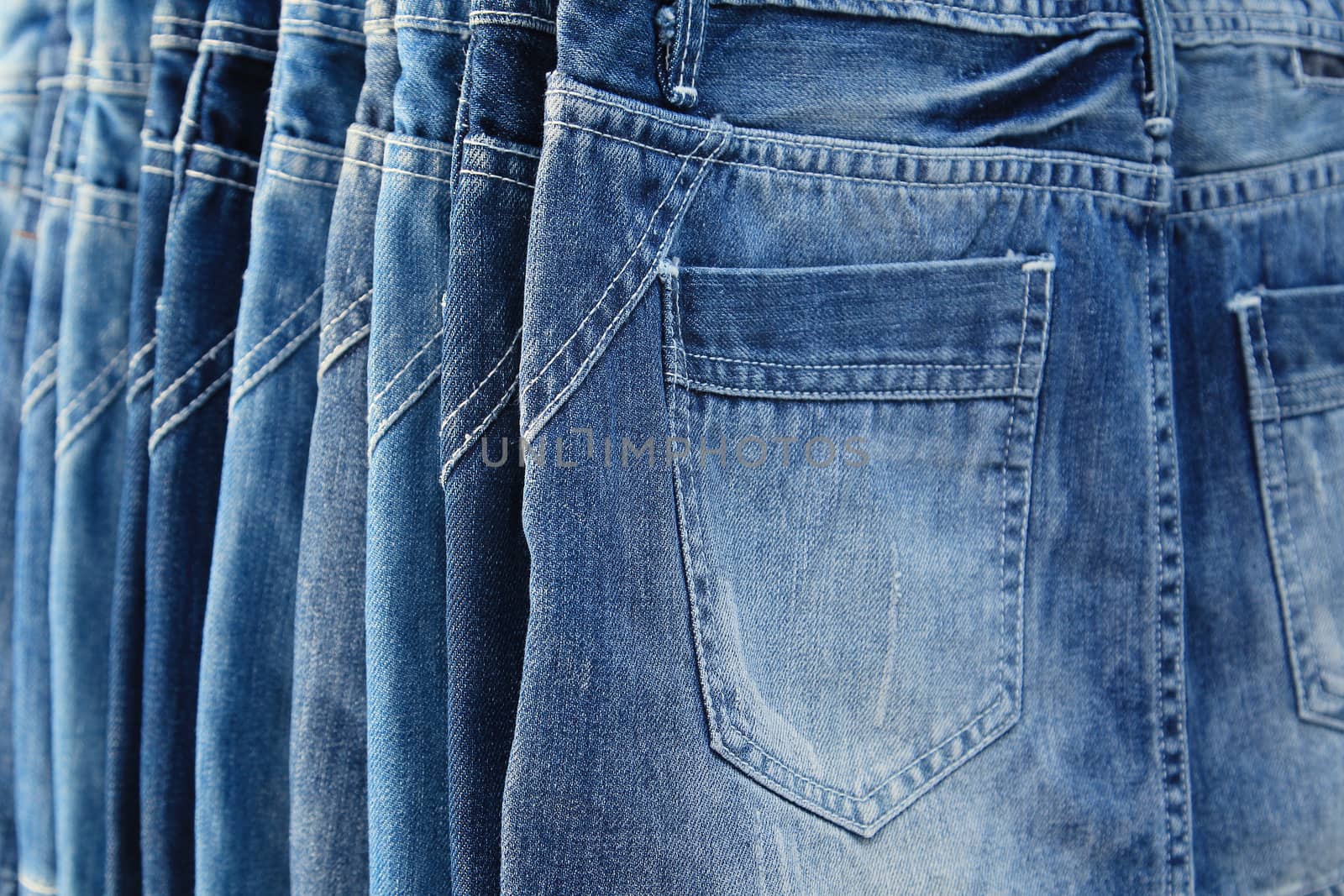 Row of hanged blue jeans