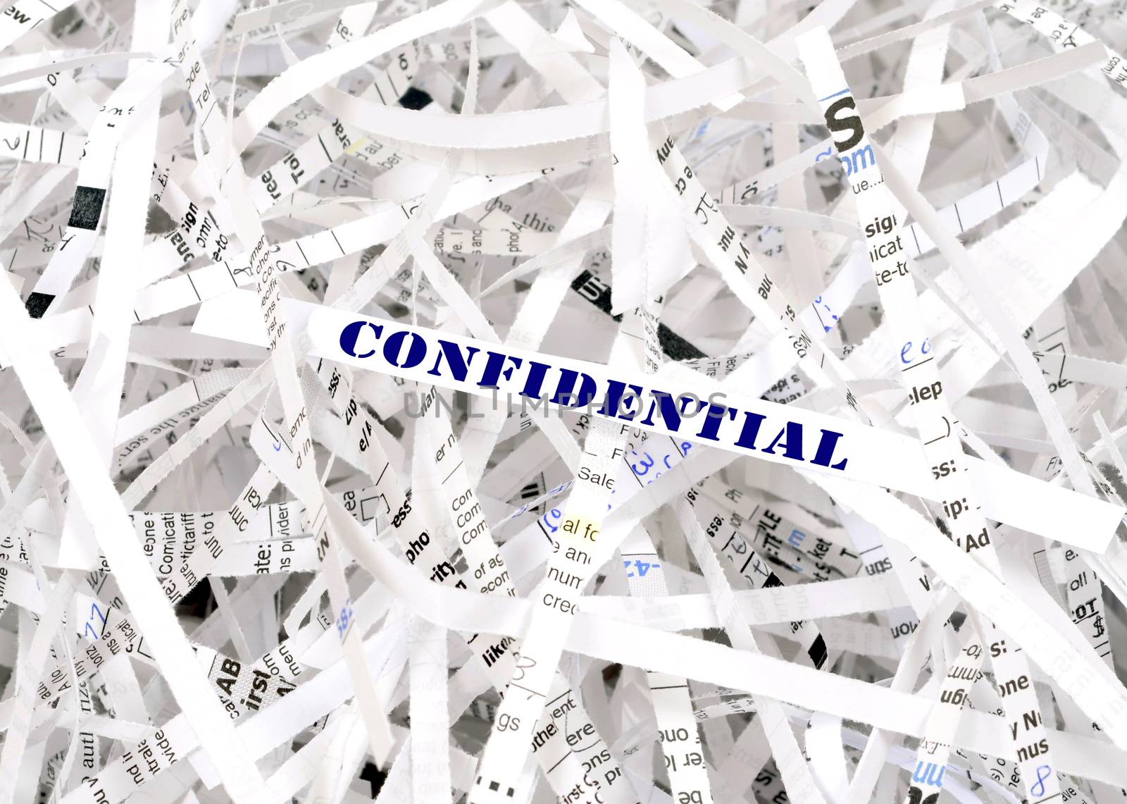 Confidential text surrounded by shredded paper. Great concept for information protection