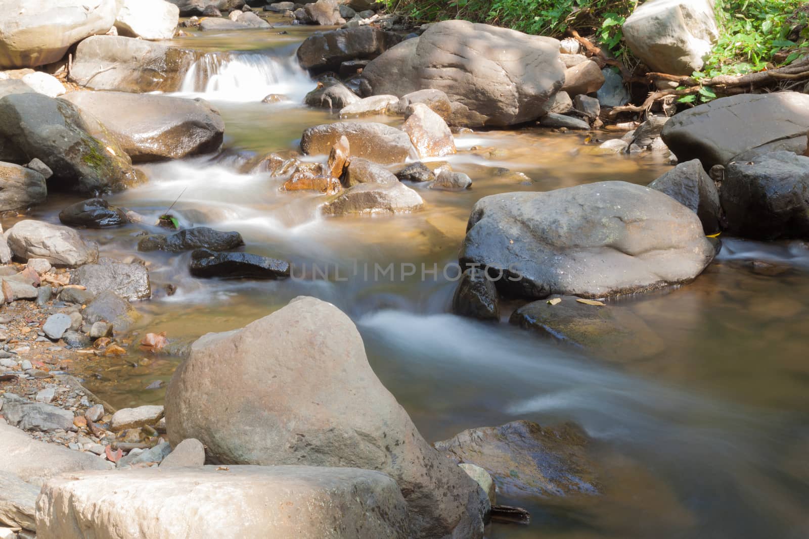 Waterfall that flows down from the mountains. Streams of water flowing down from the mountains. There is always a small stone waterfall.