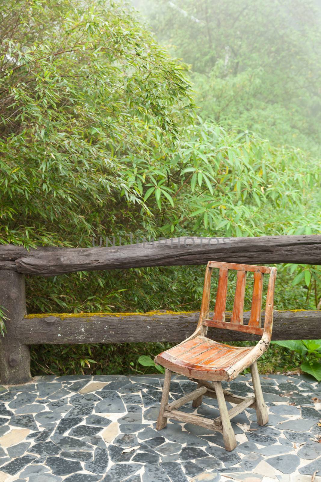 Wooden chair on the balcony. Decking made of stone The outside terrace is a tree of moist air.