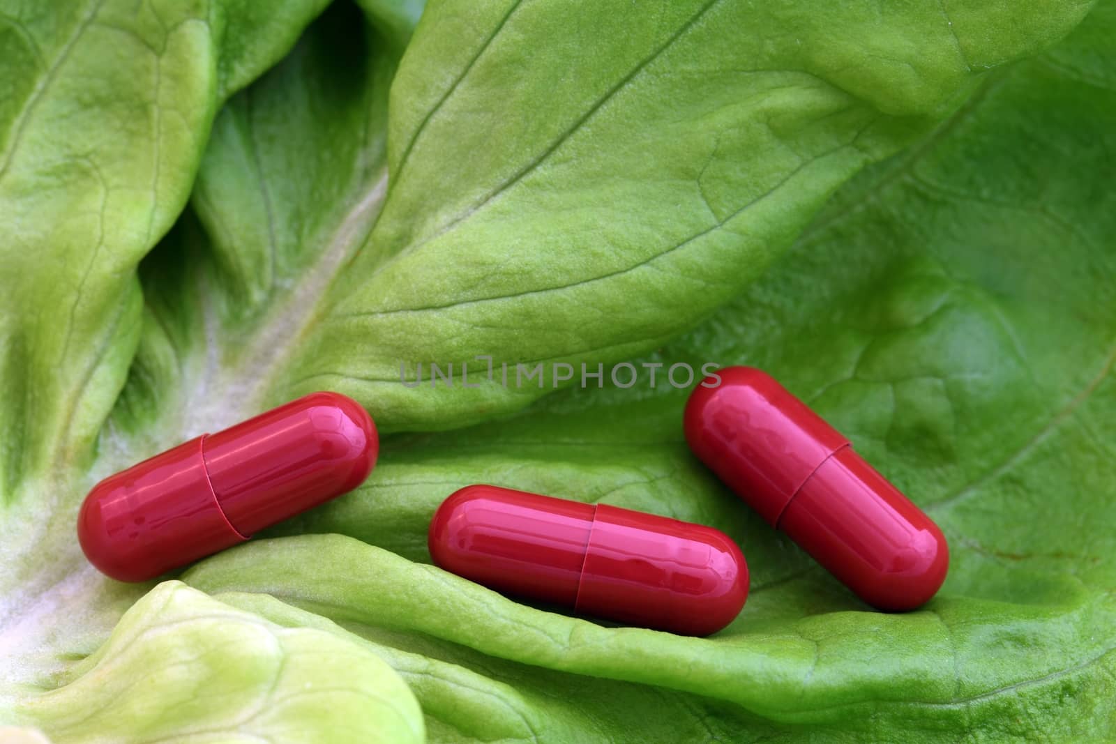 Pills on a lettuce leaf by CWeiss