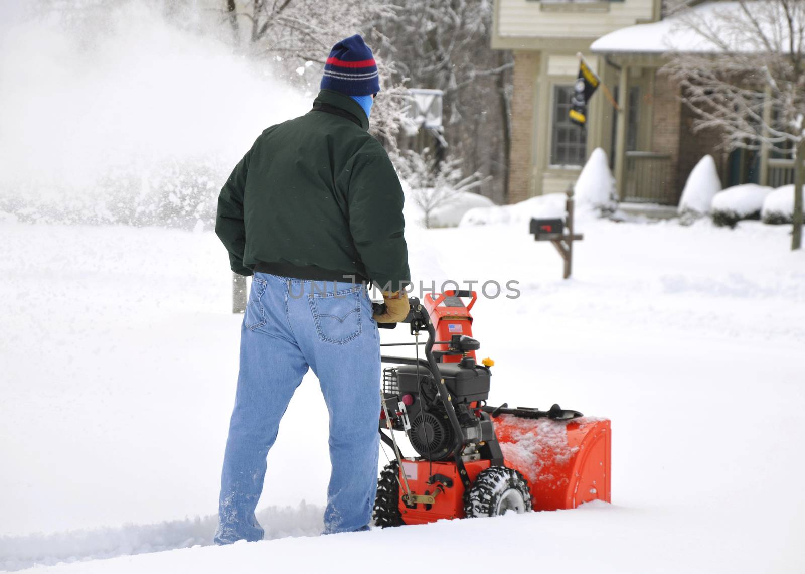Man using snow blower after a heavy snowfall