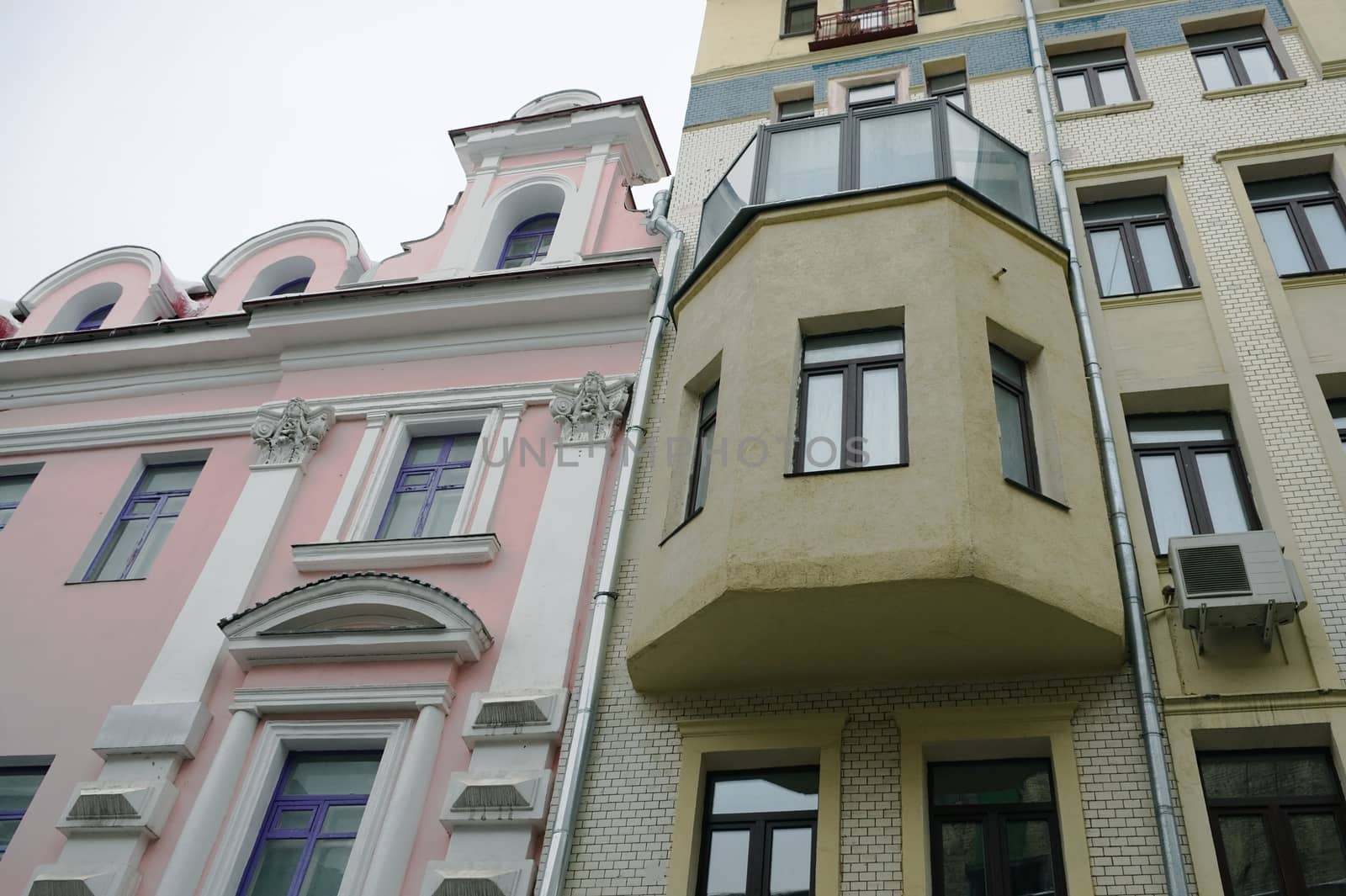 Two color old houses on the Arbat street in Moscow