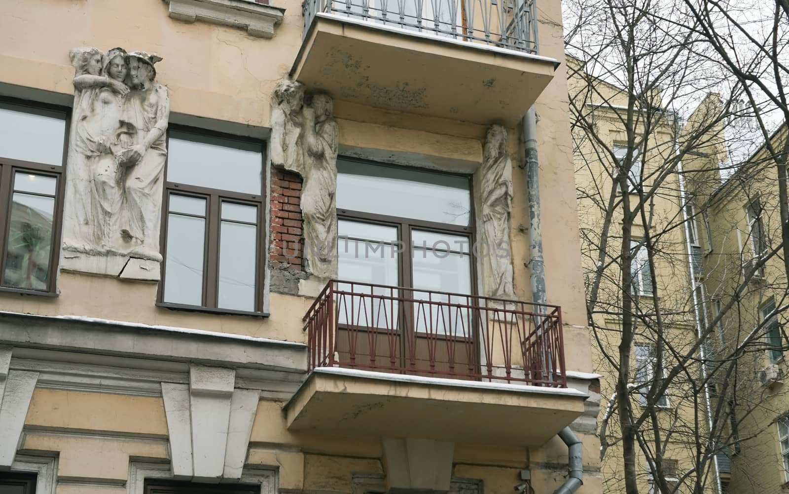 Ancient bas-reliefs on the facade of an apartment building in Moscow lane