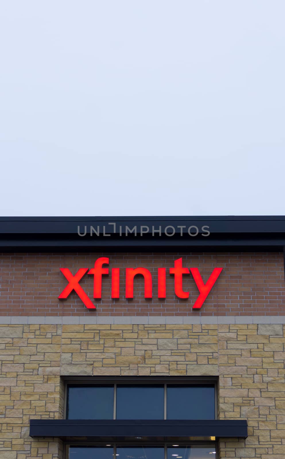 MAPLEWOOD, MN/USA - JANUARY 20, 2015: Xfinity retail store and sign. Xfinity provides cable television, broadband internet, and voip telephone.
