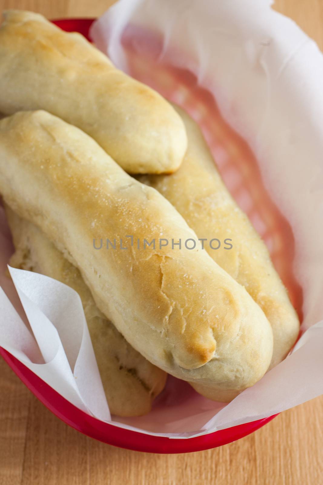 Fresh garlic breadsticks on a counter top.