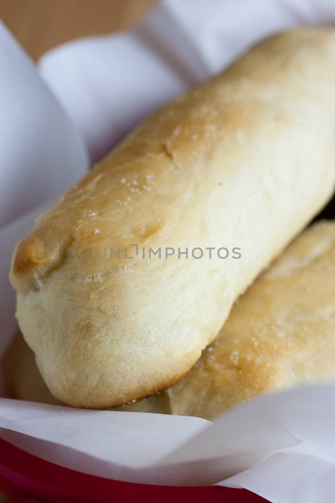 Fresh garlic breadsticks on a counter top.