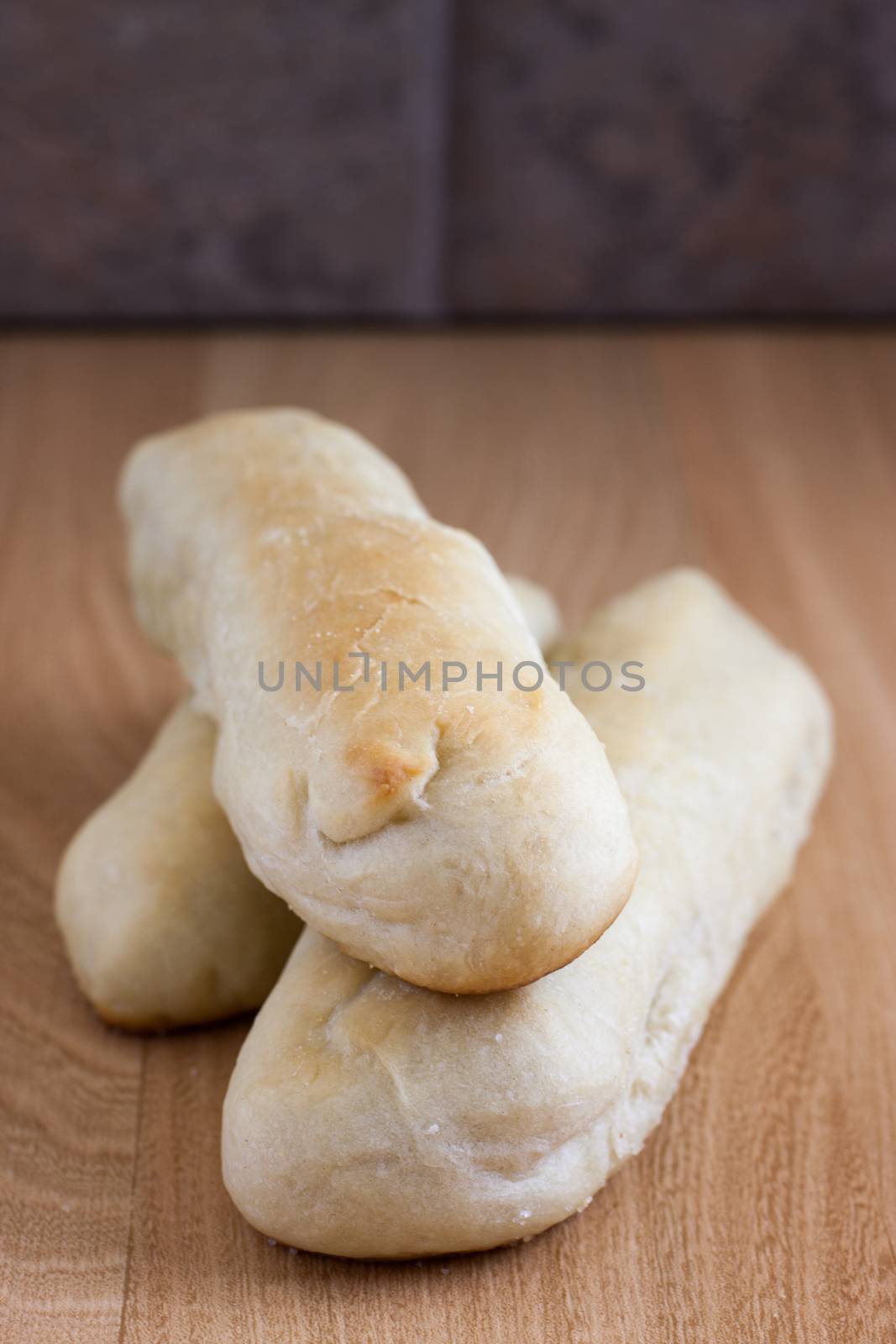 Fresh garlic breadsticks on a counter top.