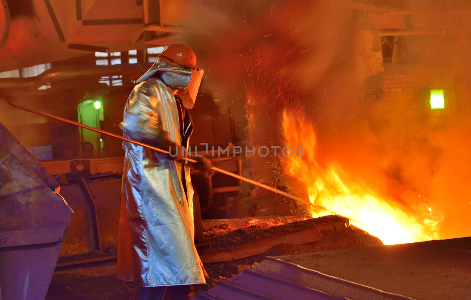 worker and production of cast iron inside of steel plant