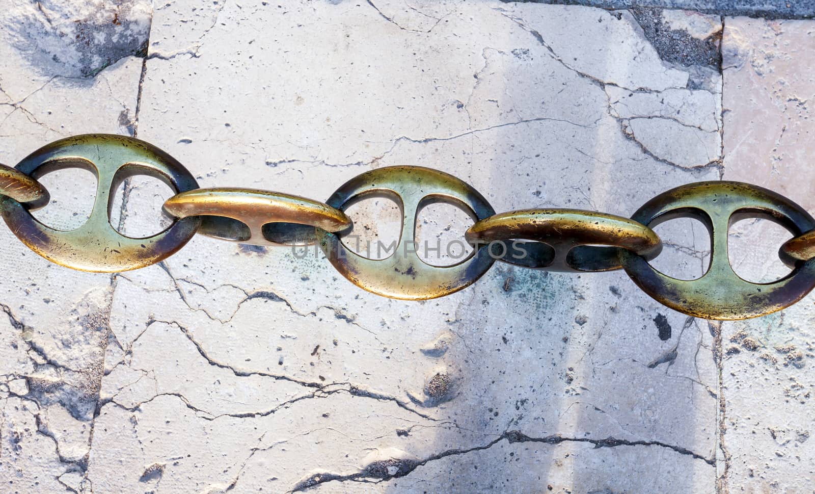Massive metal chain on sidewalk in Madrid, Spain