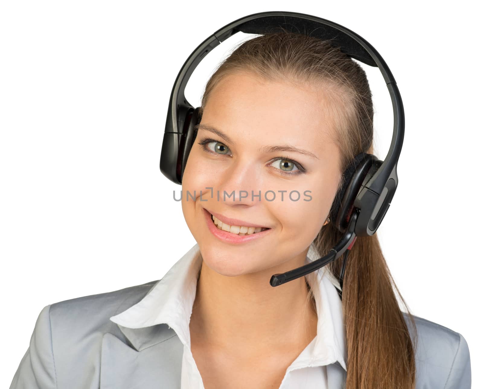 Businesswoman in headset, her head tilted slightly to the side, looking at camera, smiling. Isolated over white background