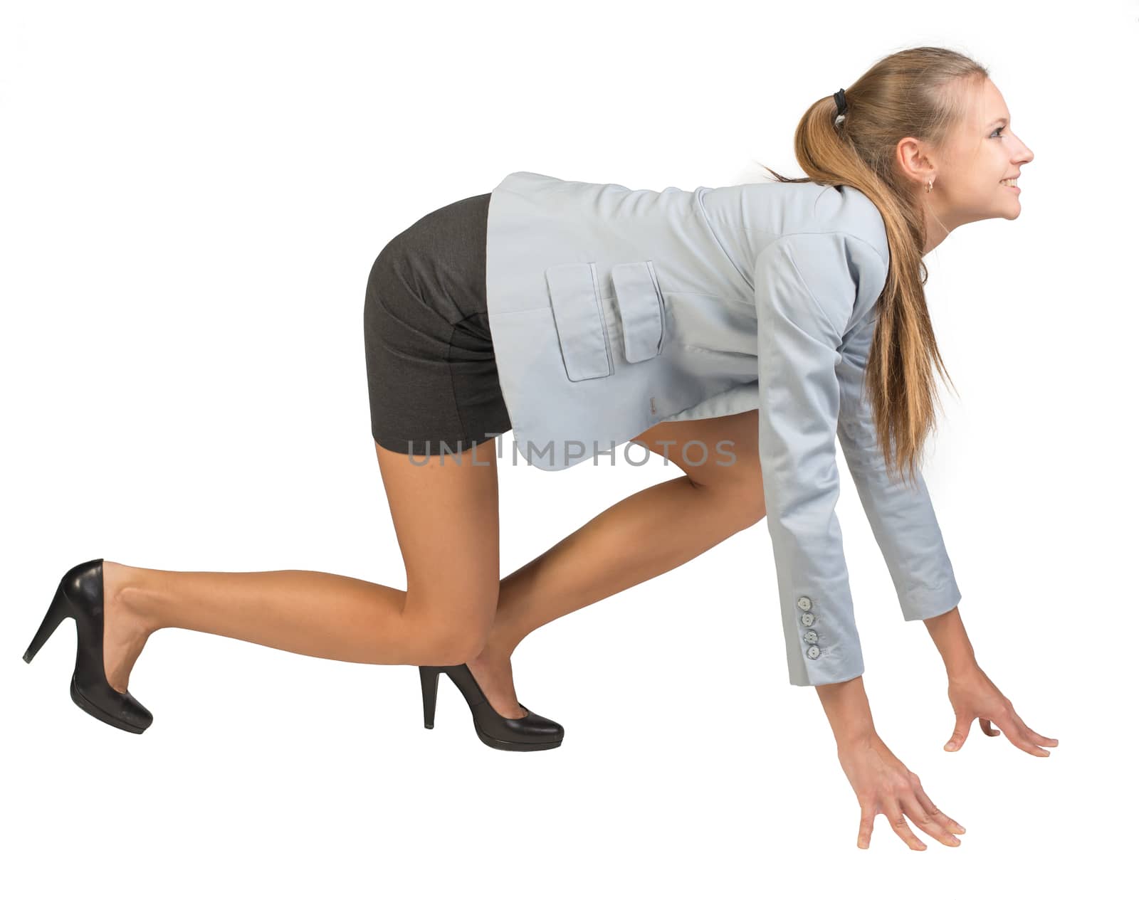 Businesswoman standing in running start pose, smiling, side view. Isolated over white background