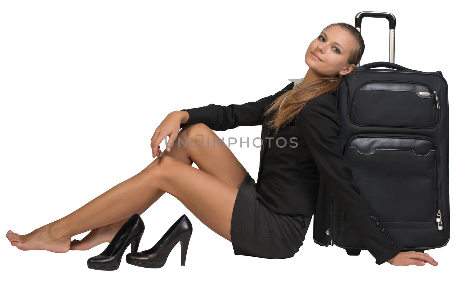 Businesswoman with her shoes off sitting hand resting on the floor, next to front view suitcase with extended handle, looking at camera. Isolated over white background