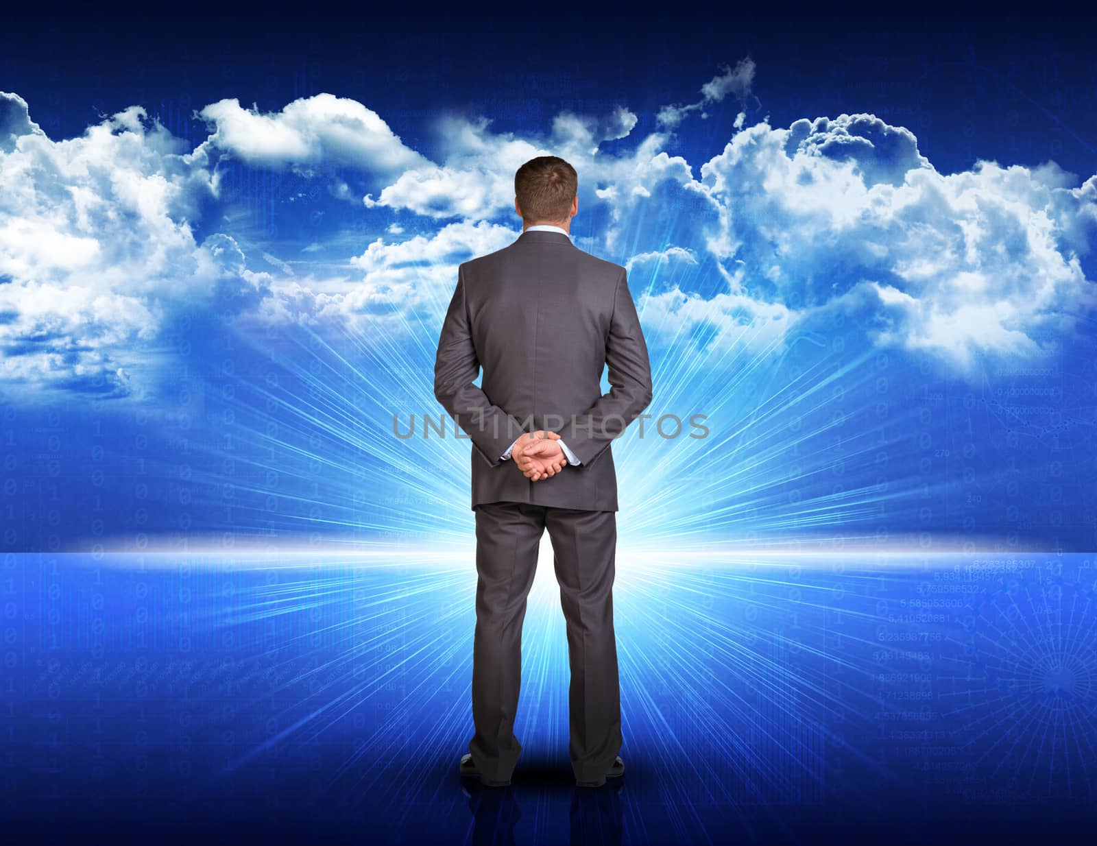 Businessman standing with his hands behind his back against digitally generated spacy blue landscape with rising sun and cloudy sky 