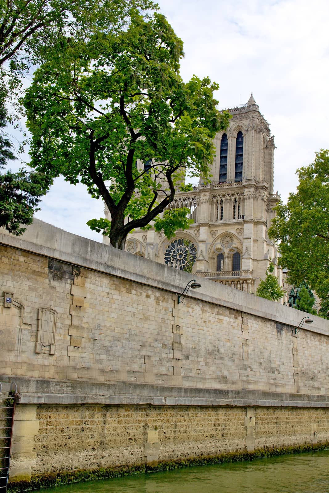 Photo shows Notre Dame de Paris or just Notre Dame that is a historic religious cathedral, on the eastern half of the Île de la Cité in the fourth arrondissement of Paris, France.