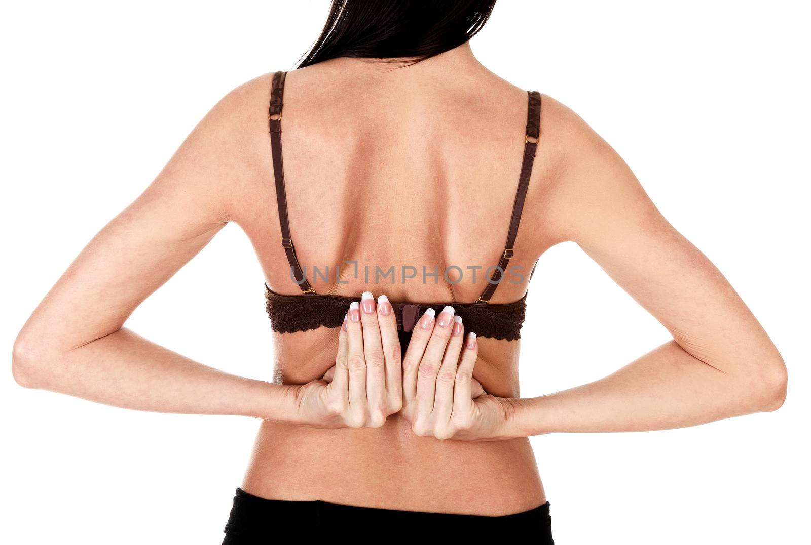 Rear view of a woman taking off her bra, isolated over white background