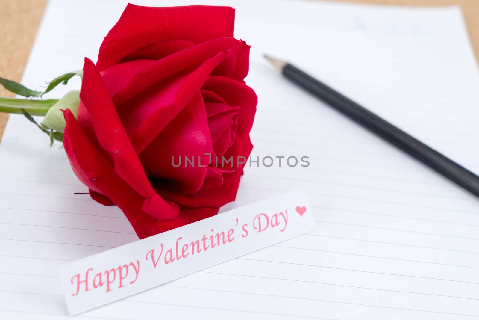 Cardboard, corkboard with note paper with pencil and rose beside for romantic planning, space for text