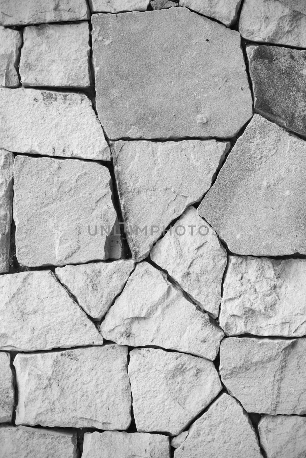 black and white and multi-sized, pale rocks wall grunge texture background.
