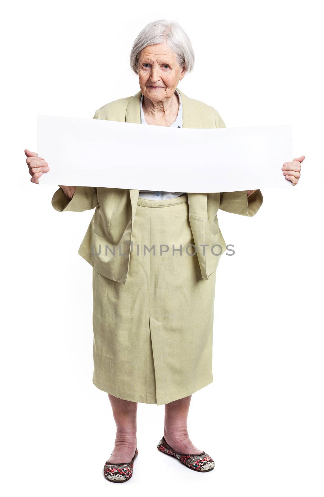 Happy elderly lady holding blank sheet in hands over white