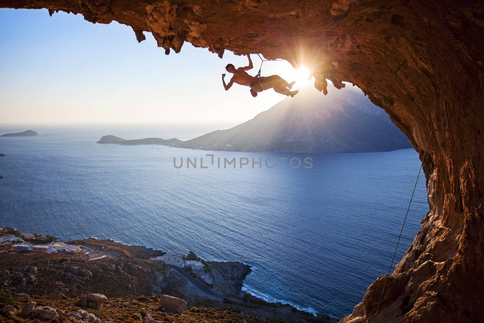 Male rock climber at sunset by photobac