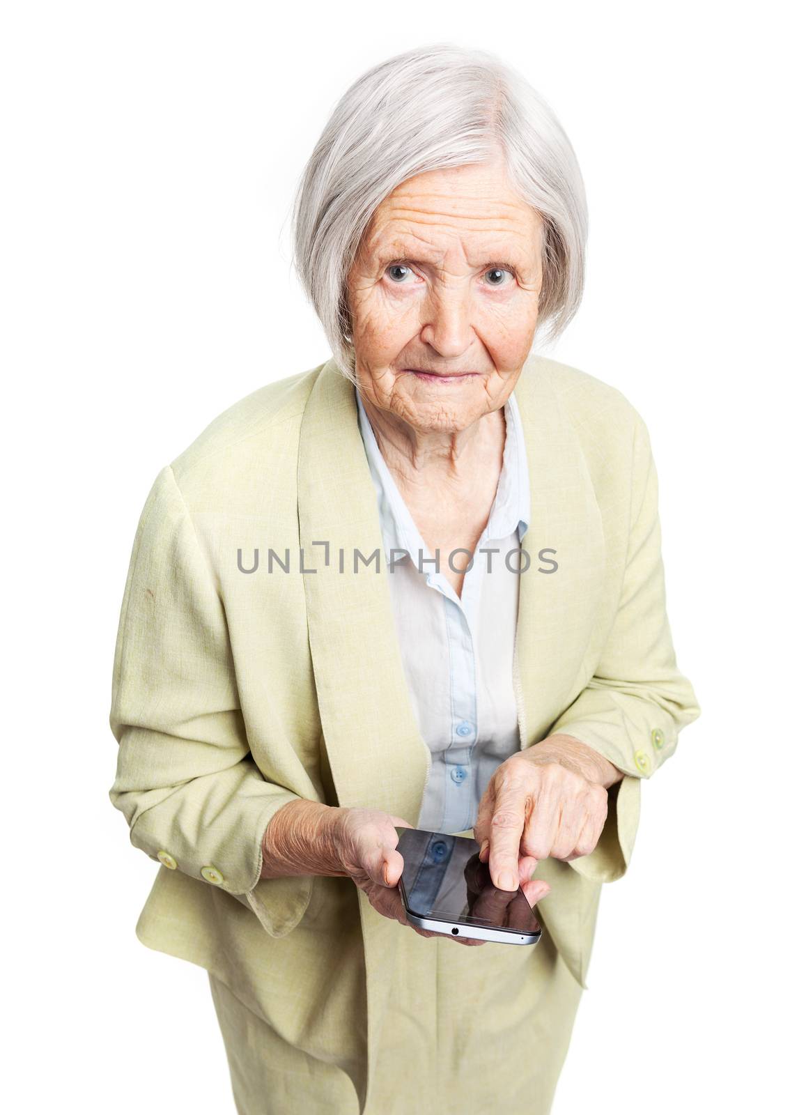 Senior woman holding mobile phone and looking at camera over white