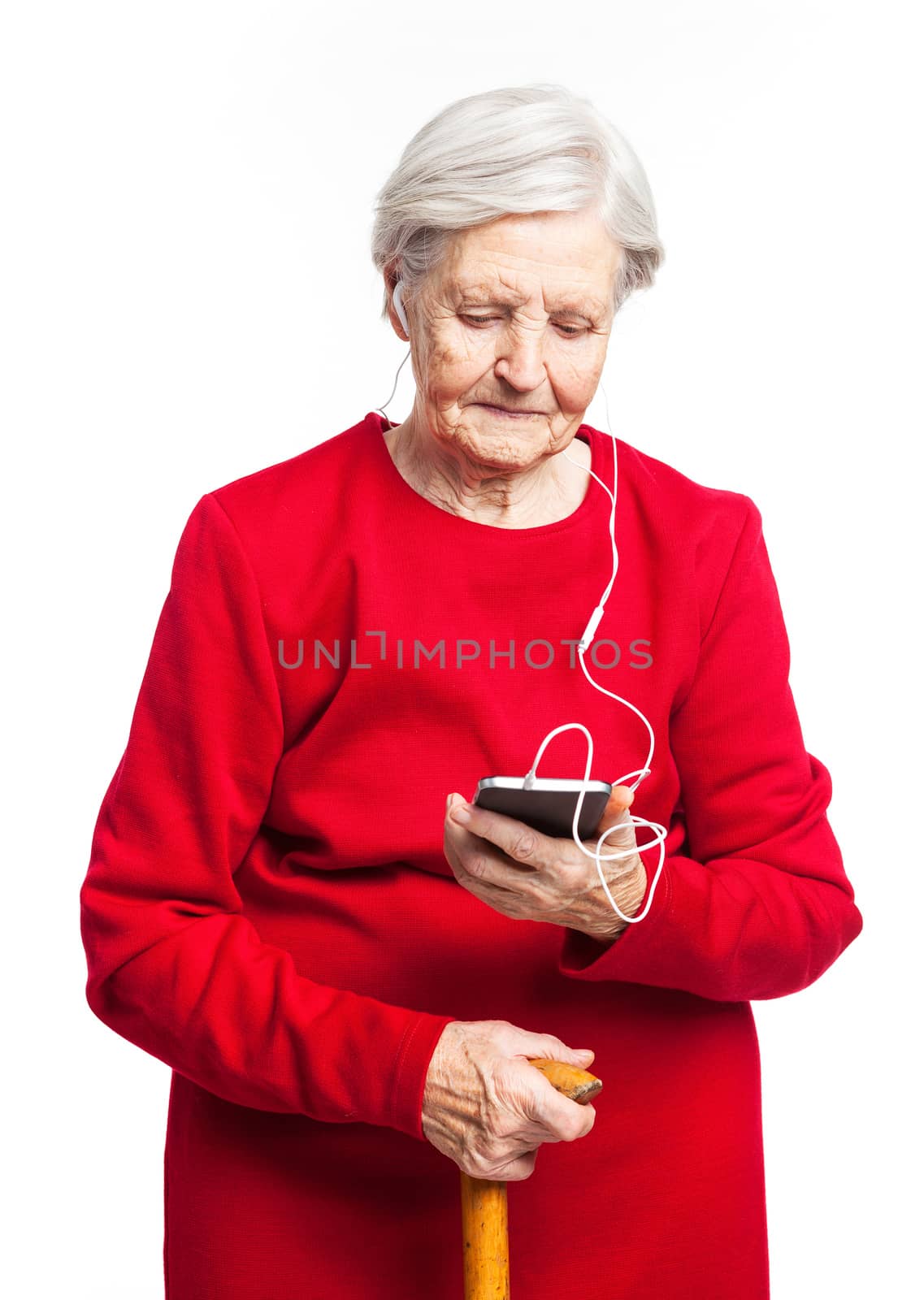 Senior woman listening to music over white by photobac