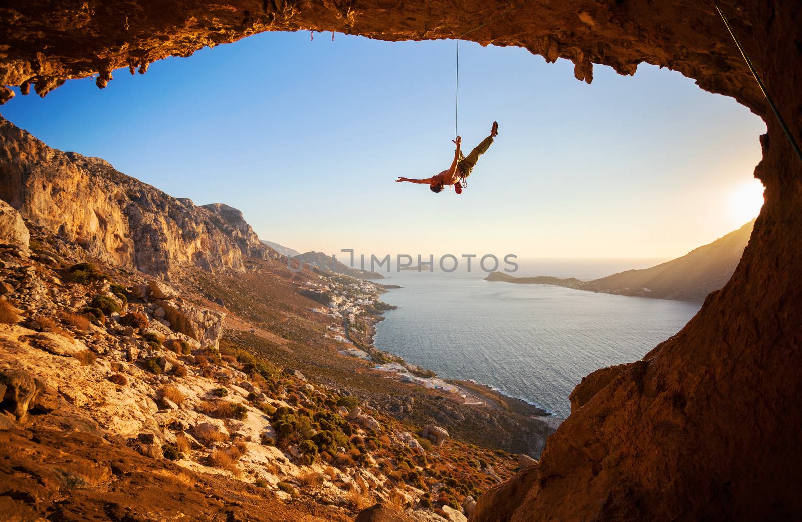 Silhouette of a rock climber falling of a cliff by photobac