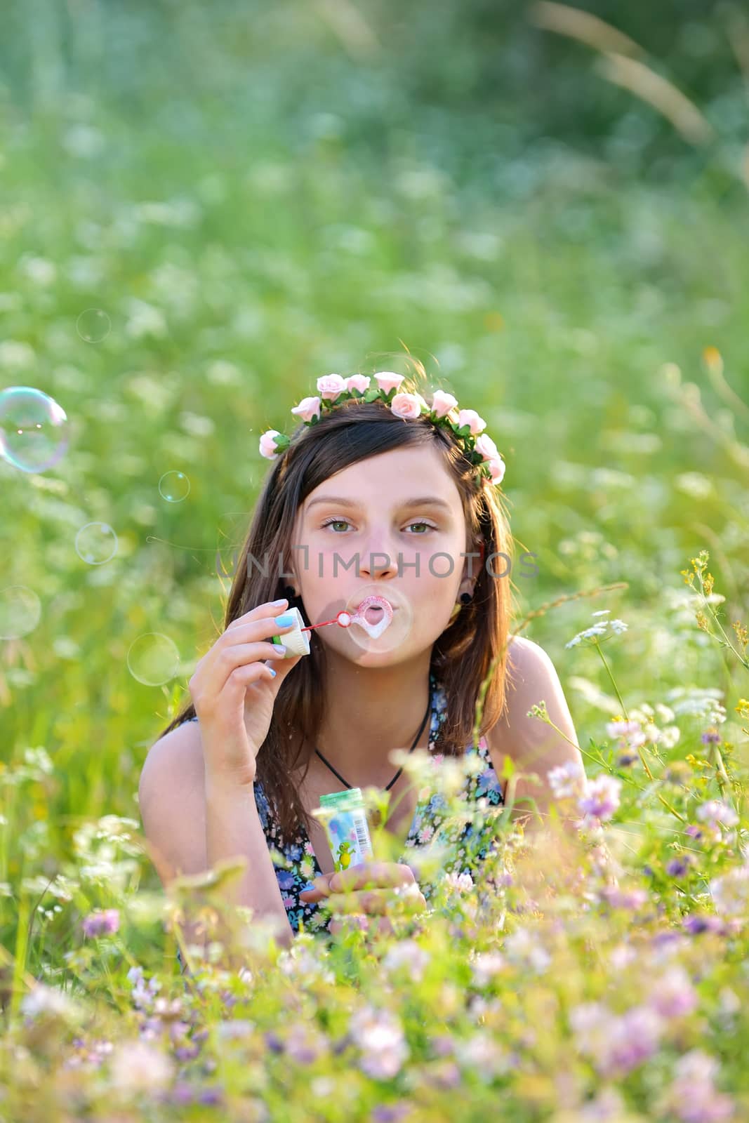 Young beautiful girl blowing bubbles