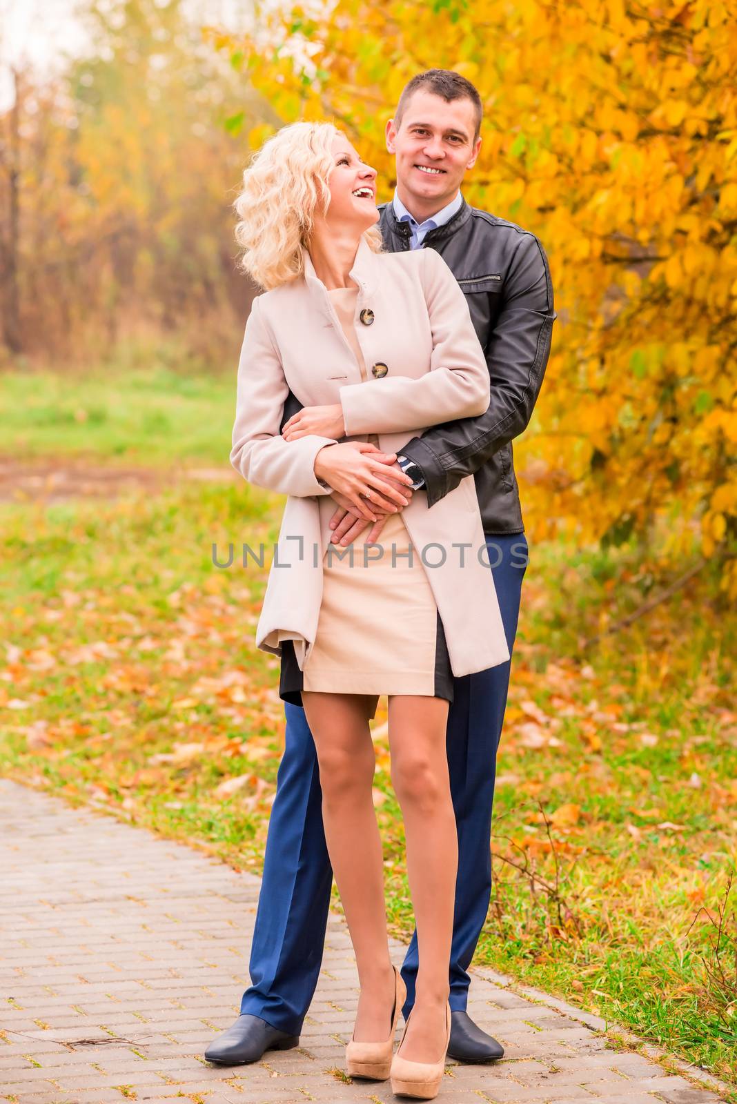 young couple walking in the park and laughing
