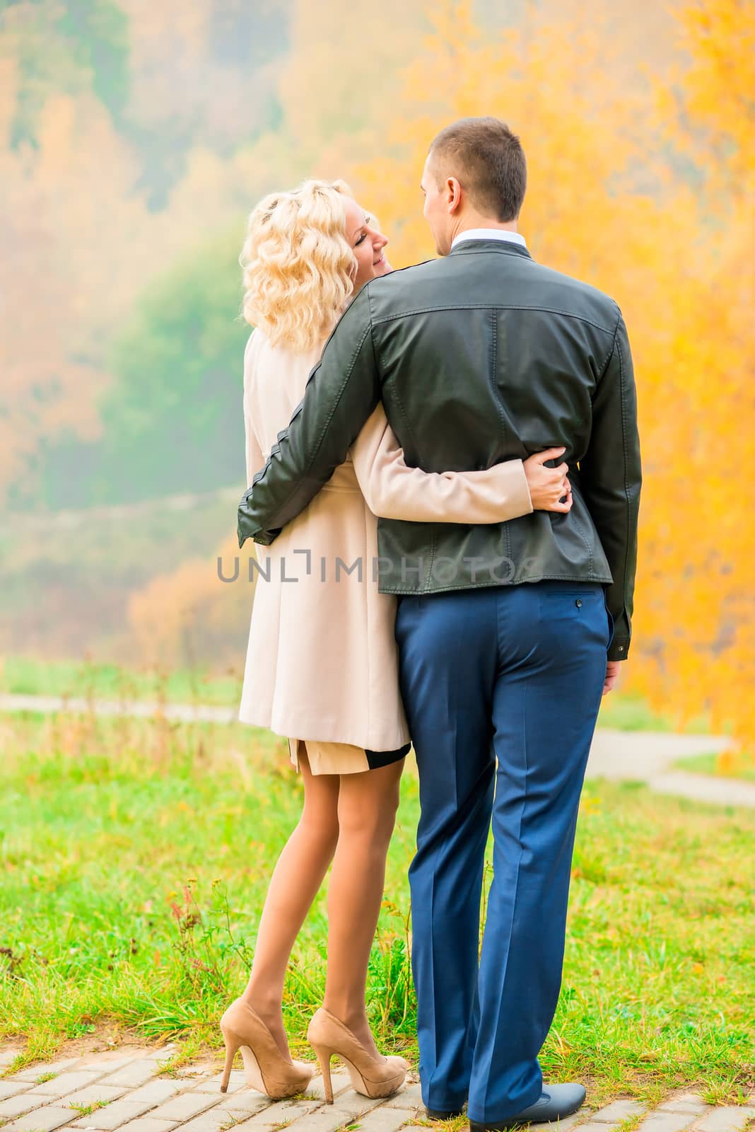 young couple embracing in autumn park