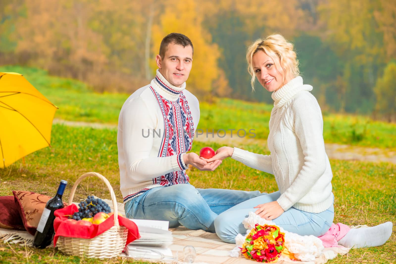 man and woman hold in their hands a red apple by kosmsos111